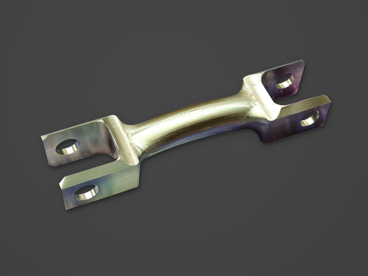 A stainless steel DSSR arm with a forked end, on a charcoal ground