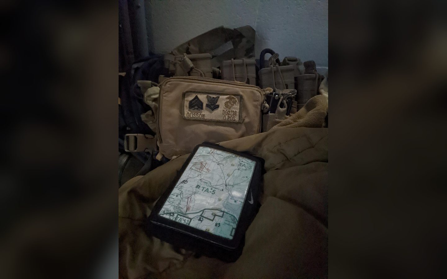 A map on a rugged tablet on top of a pack