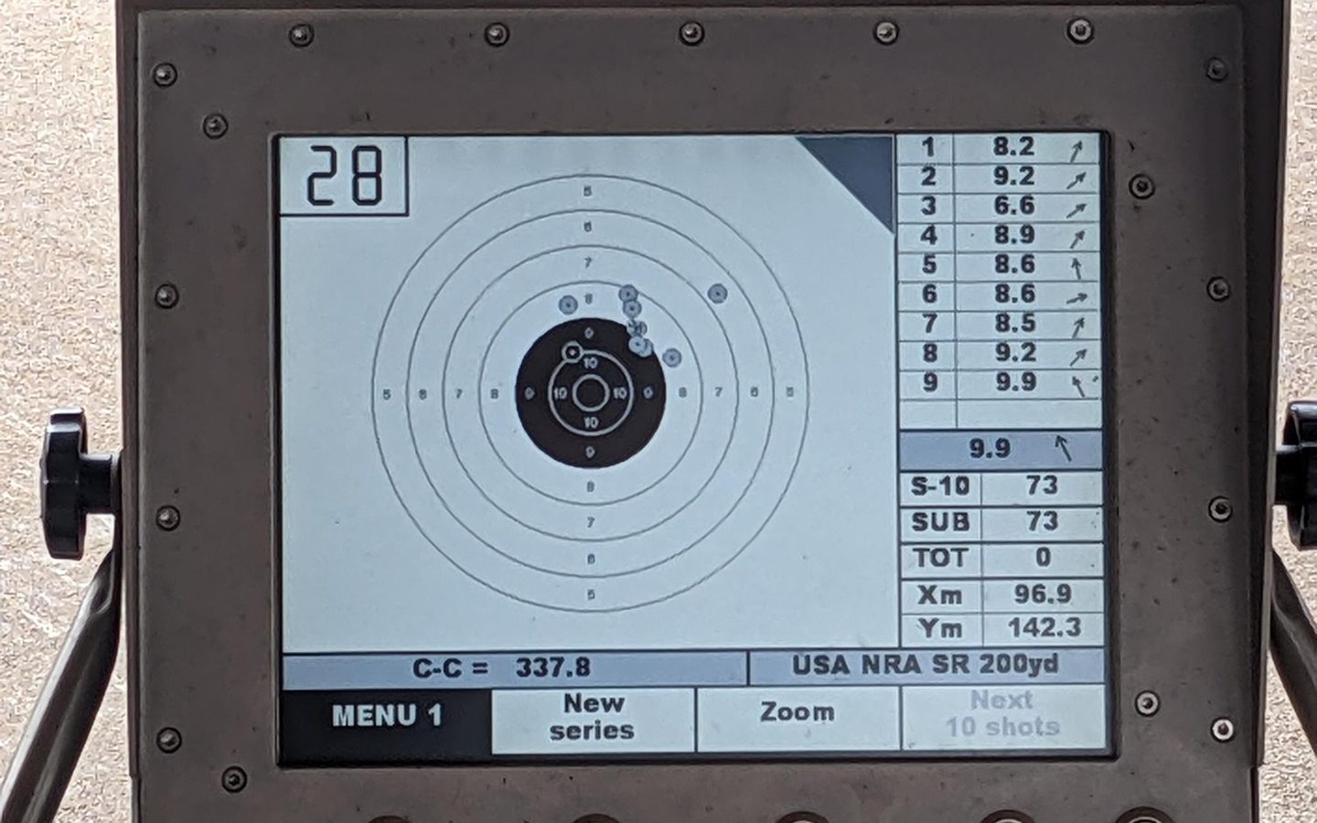 An electronic target monitor showing a tight ten-shot group at 200 yards