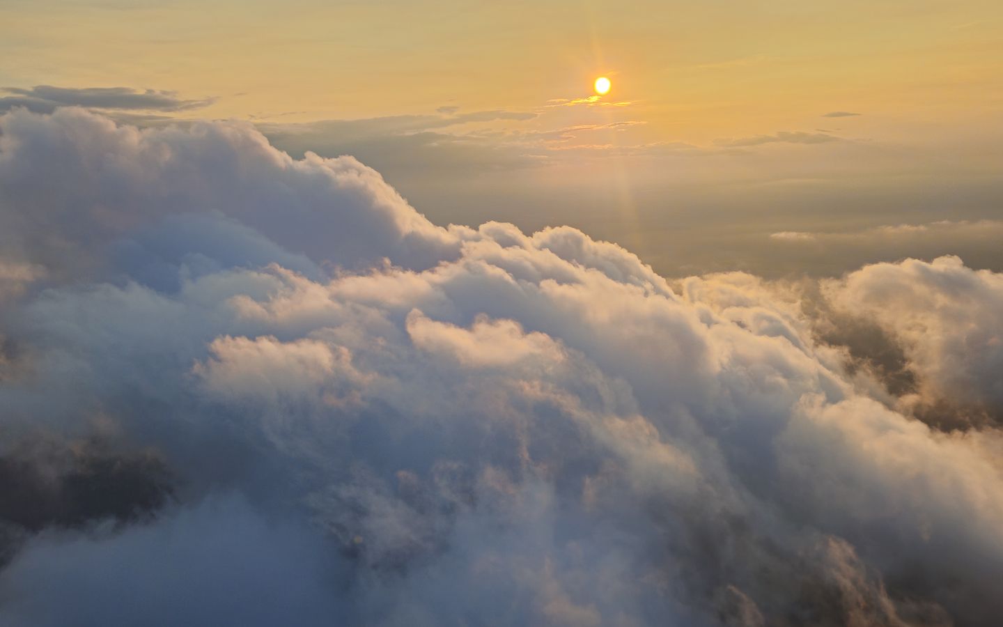 Sunset over a sea of cloud from the air
