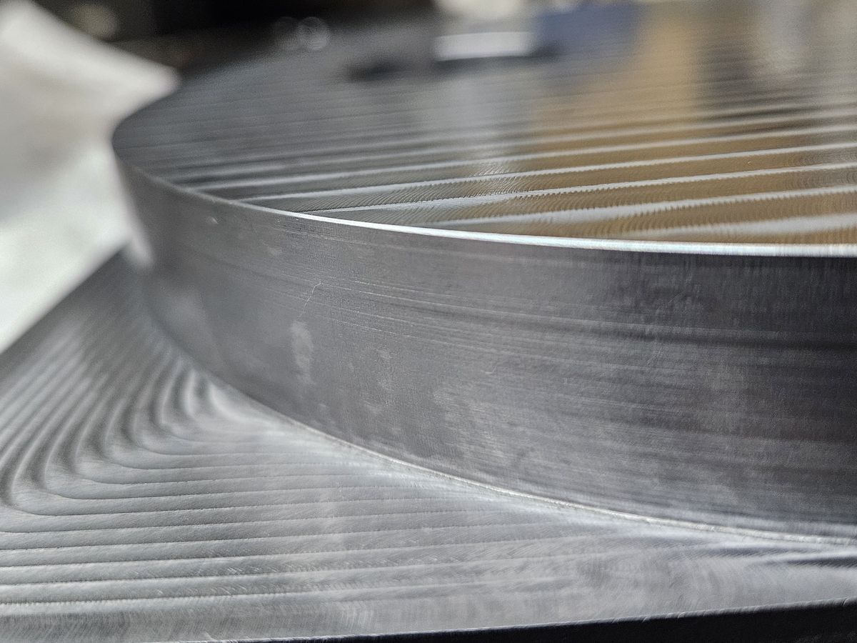 The machined face and edge of a round steel plate