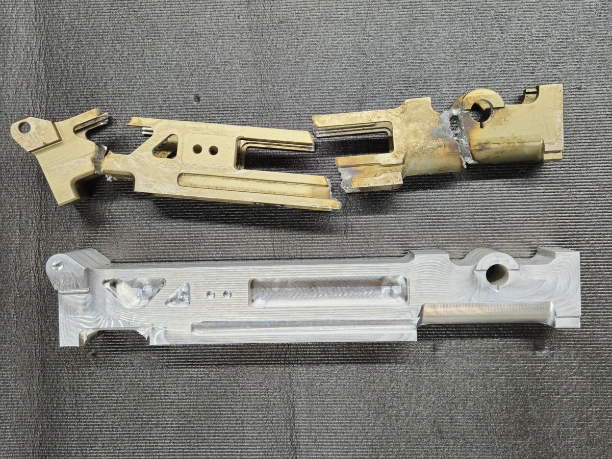 A new machined aluminum part below the broken original it was made from