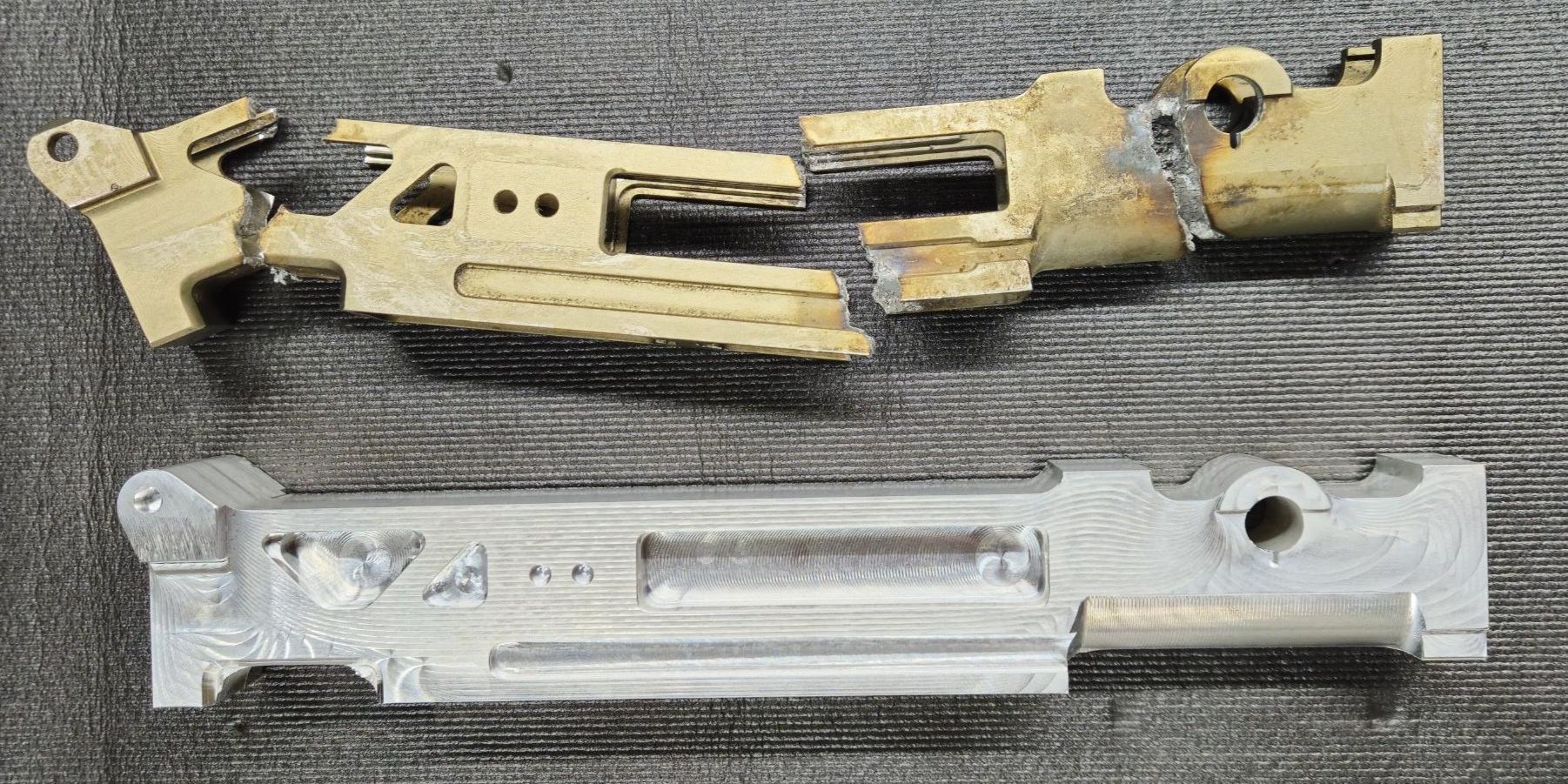 A new machined aluminum part below the broken original it was made from