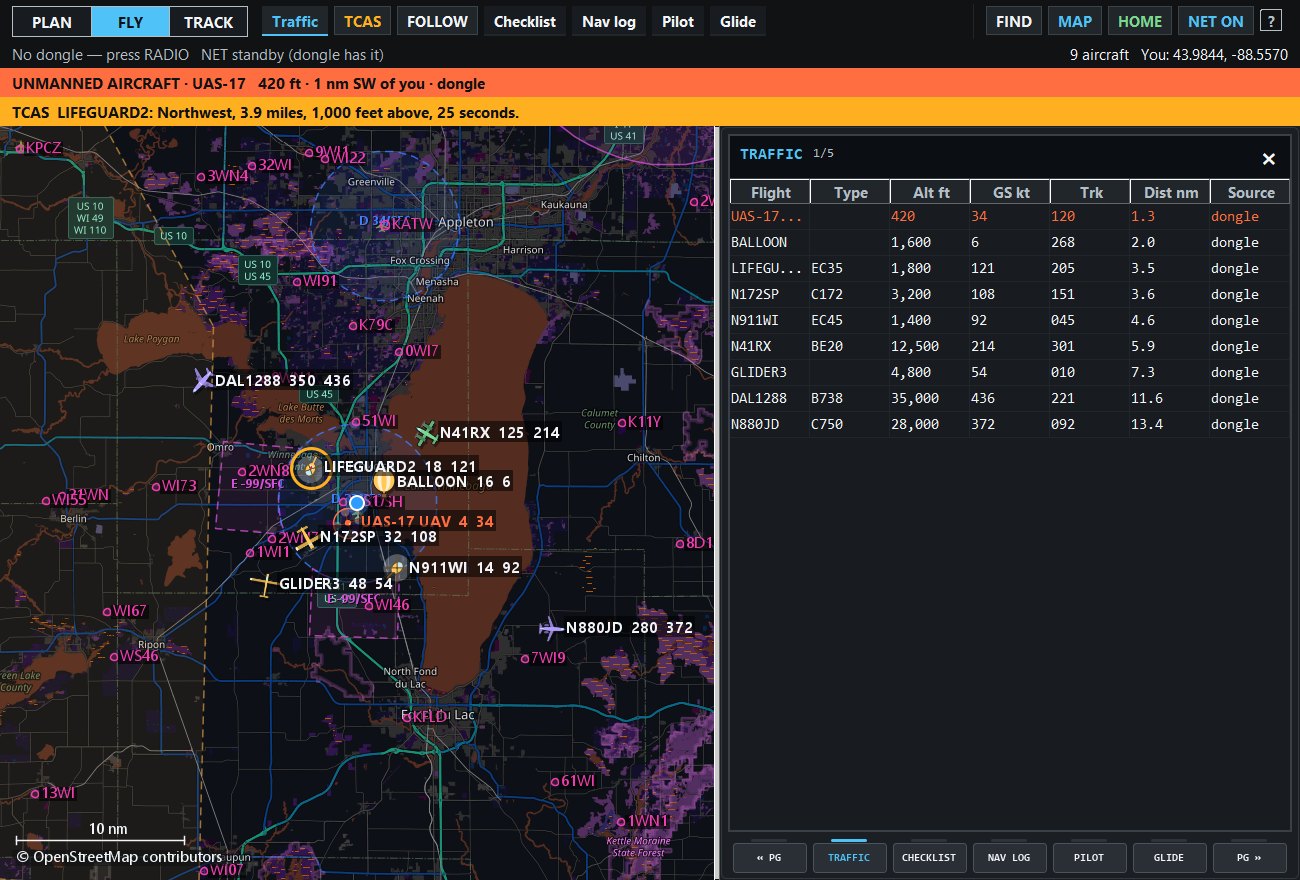 The app at night: live aircraft and an unmanned aircraft warning over a dark chart, traffic table beside it